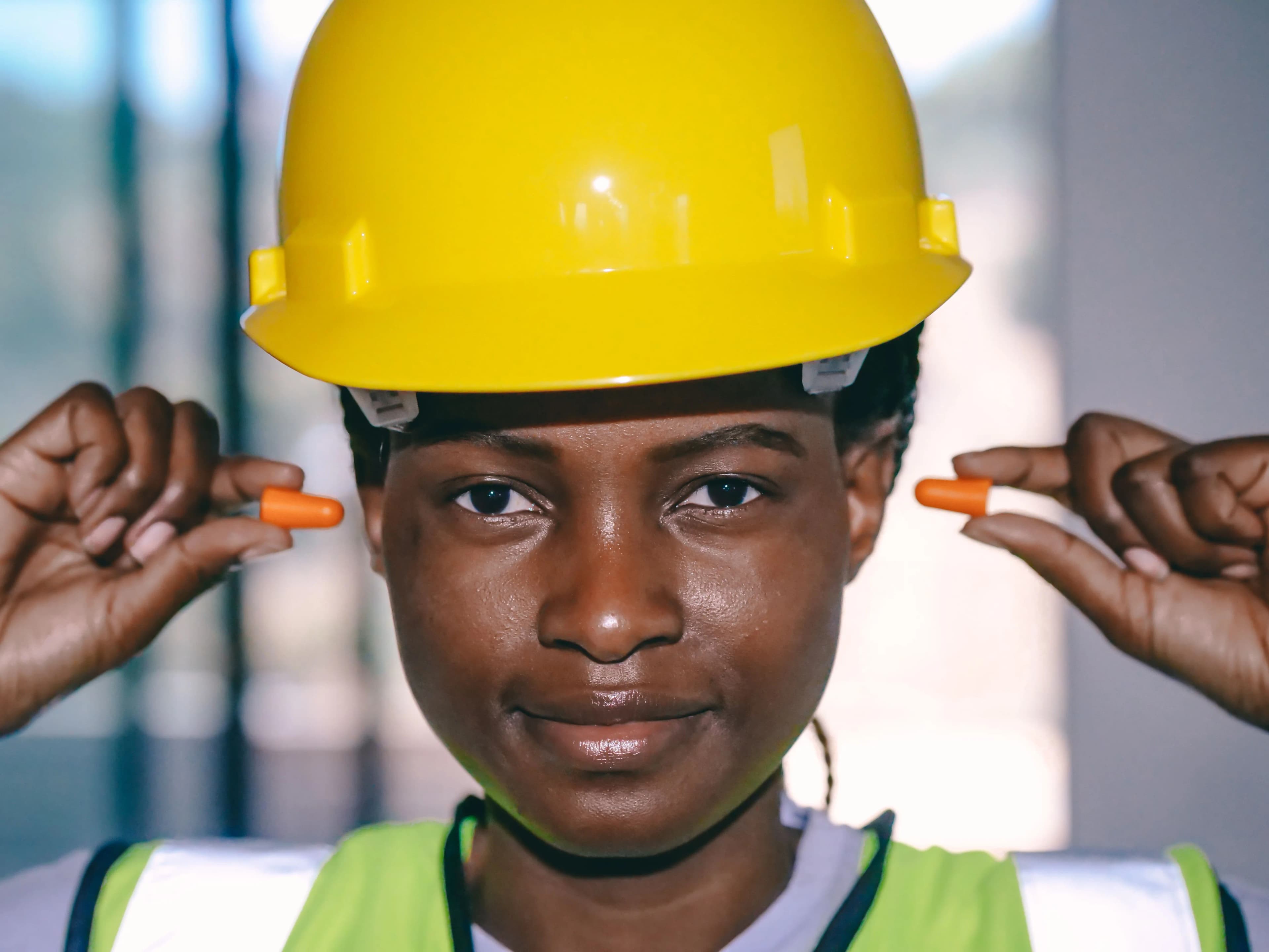 Worker fitting earplugs before a task